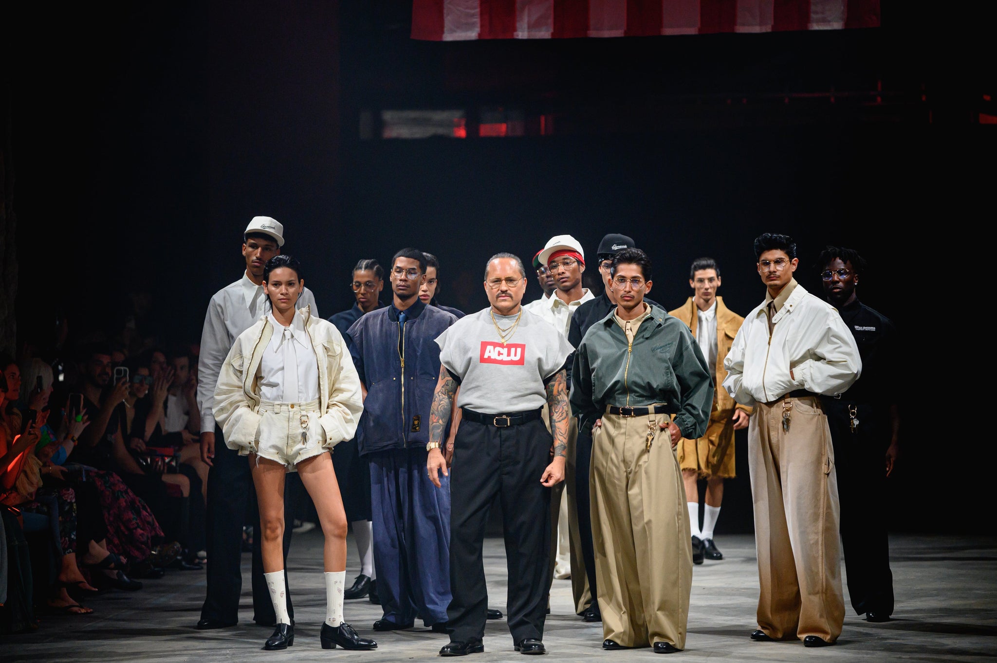 Designer Willy Chavarria standing on the runway beside all his models 